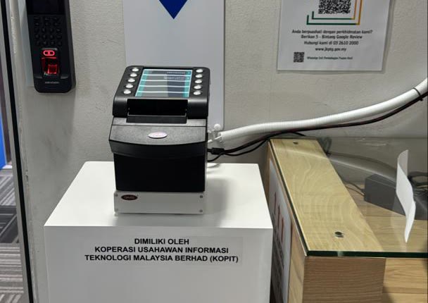 KOPIT-owned queue ticket dispenser machine at a government office